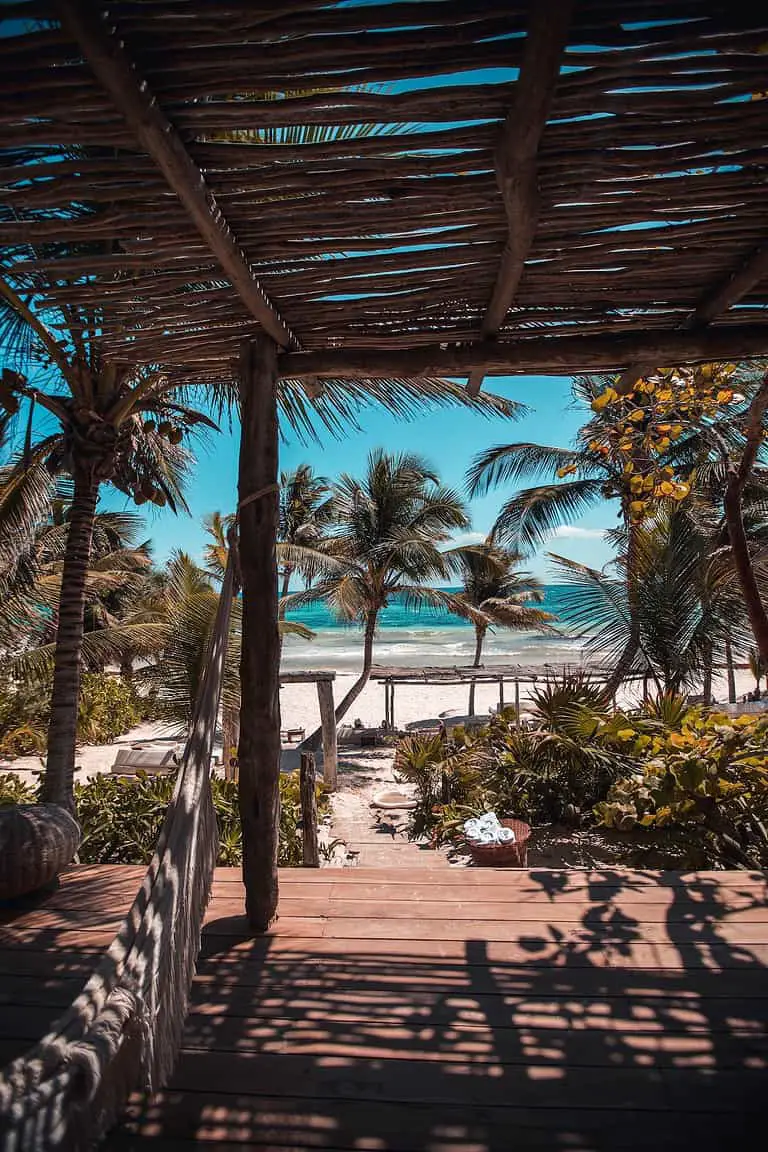 An enchanting view of the Tulum ruins overlooking the turquoise Caribbean Sea in Cancun, Mexico, reflecting the exploration of historical sites by Juntos Journeys.